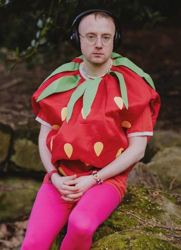 Alex Paxton dressed in a strawberry outfit